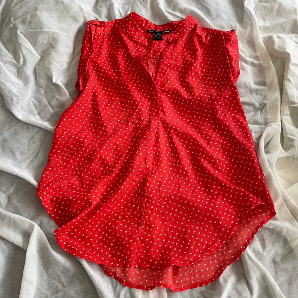 Bright red sleeveless top.